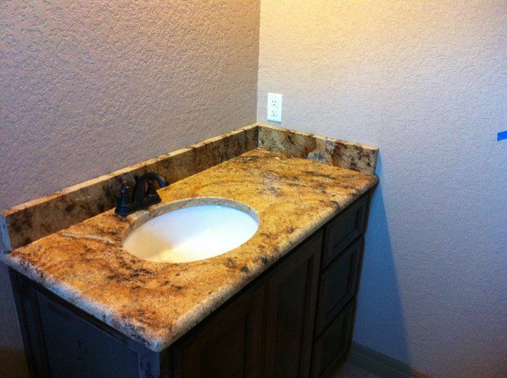 A bathroom sink with a marble counter top