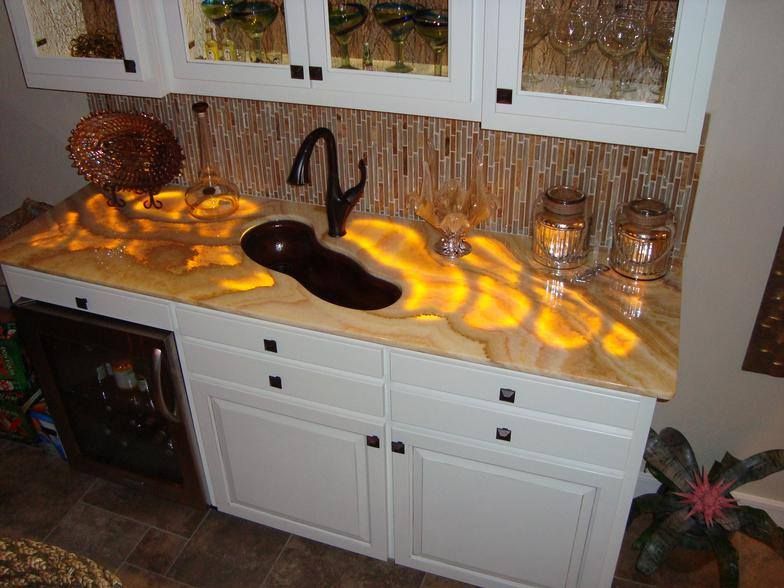 A kitchen with a sink , cabinets and a refrigerator