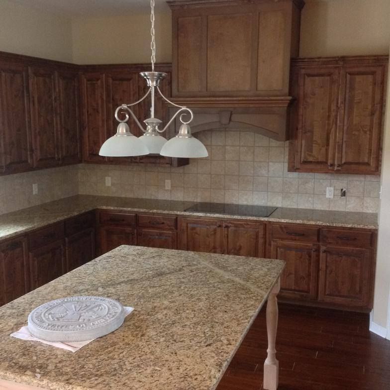 A kitchen with wooden cabinets and granite counter tops