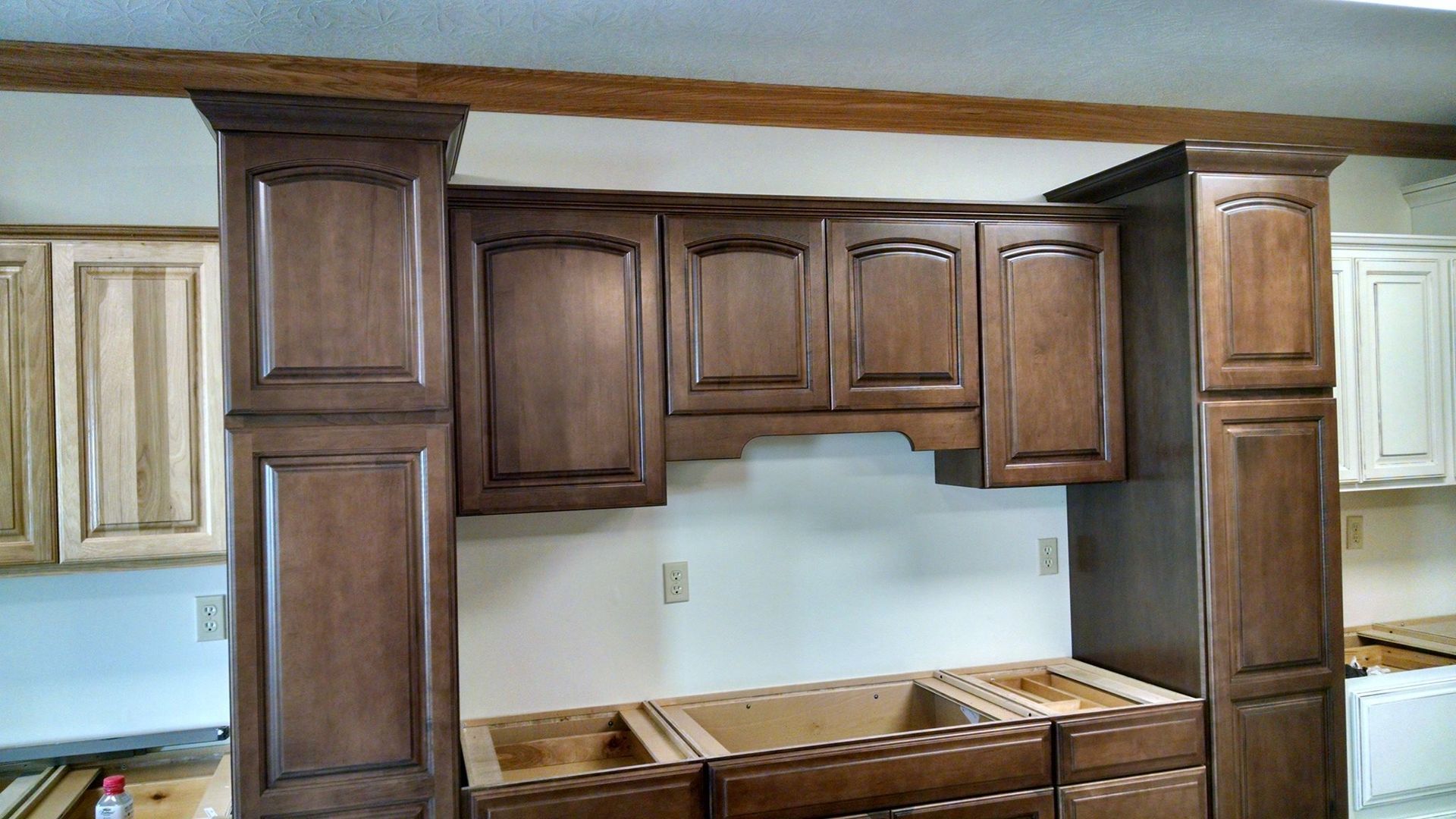 A kitchen with wooden cabinets and a sink.
