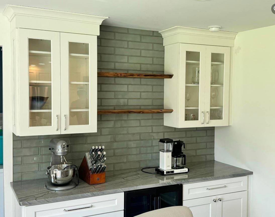 A kitchen with white cabinets and granite counter tops