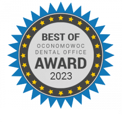 Best of Oconomowoc Dental Office Award 2023: Blue and gray circular seal with stars.
