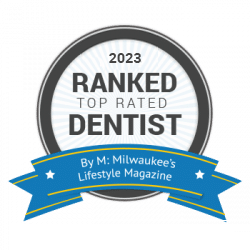 2023 Ranked Top Rated Dentist badge by M: Milwaukee's Lifestyle Magazine; circular design, black, white, and blue.
