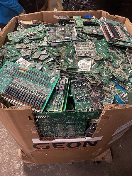 A cardboard box filled with lots of electronic components.