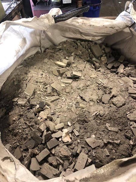 A bag filled with rocks and dirt is sitting on a table.