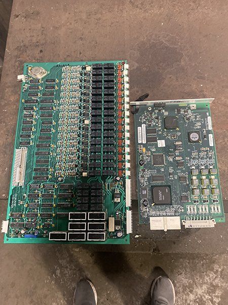 Two computer boards are sitting next to each other on a table.