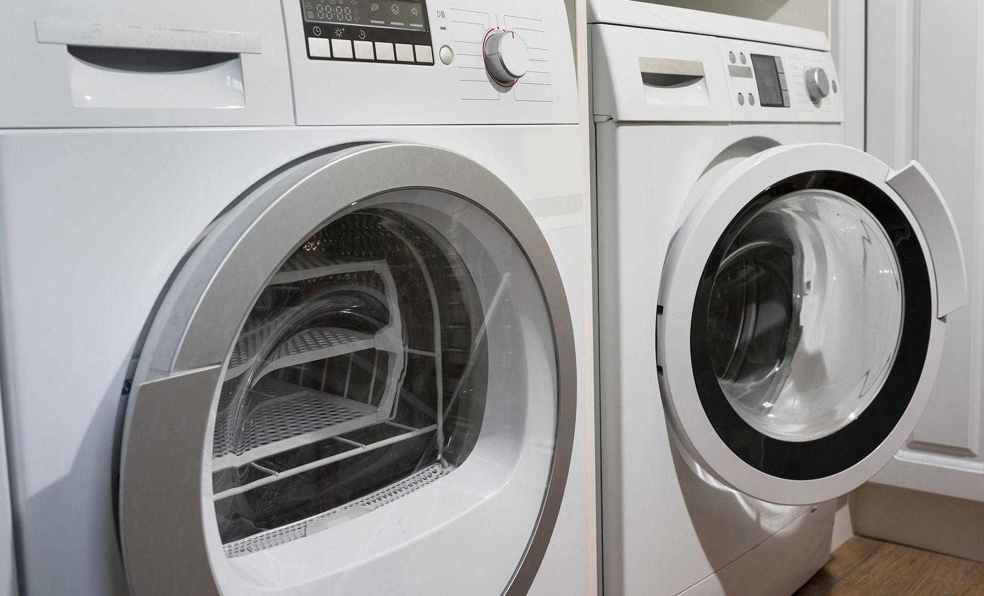 A washer and dryer are sitting next to each other in a laundry room.