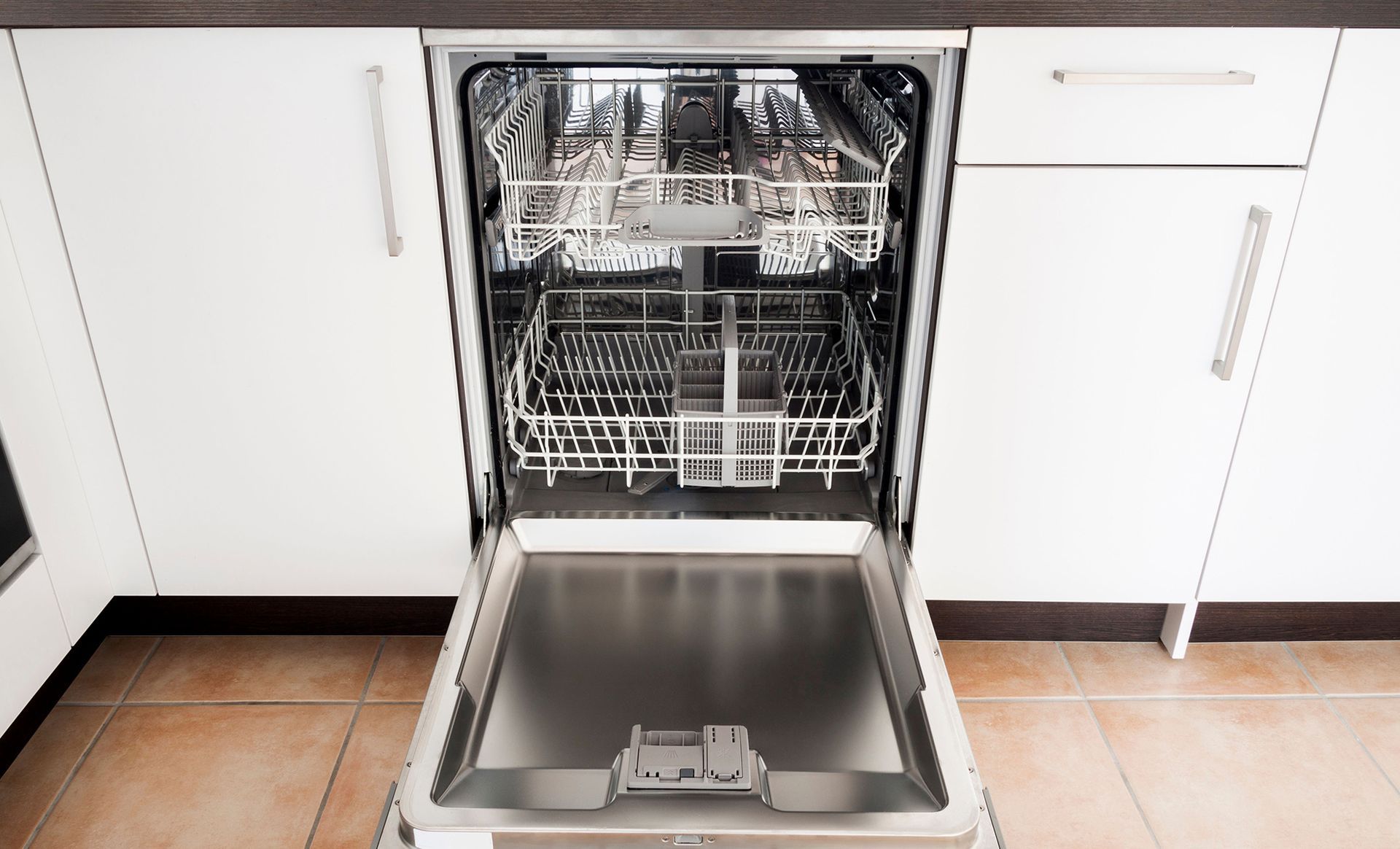 An open dishwasher in a kitchen with the door open