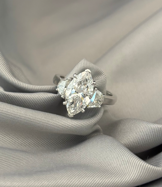 A close up of a diamond ring on a cloth