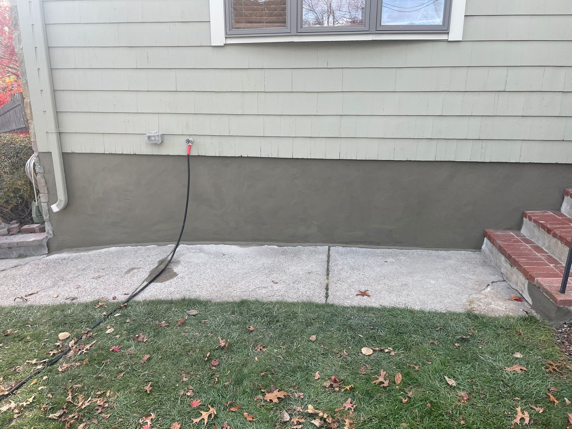 White Ford pickup truck in front of a house. The truck has a logo that reads "All Pro".
