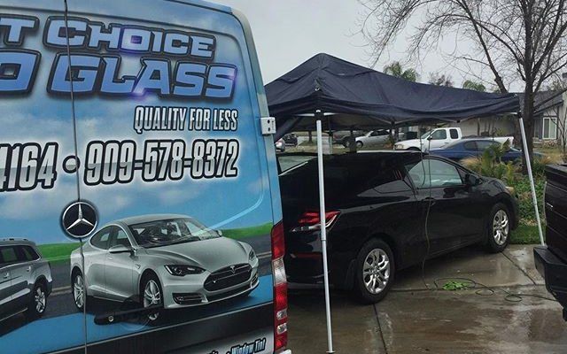 A choice glass van is parked in a parking lot