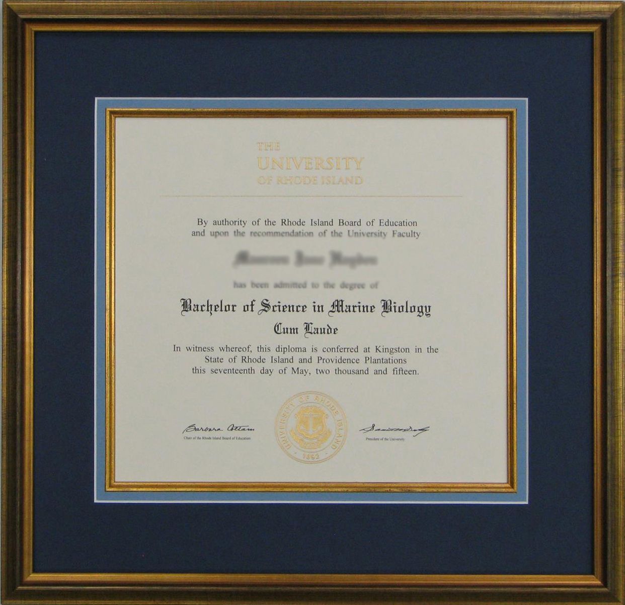 Framed diploma for a Master of Science in Marine Biology. Gold frame, dark blue matting, and beige certificate paper.