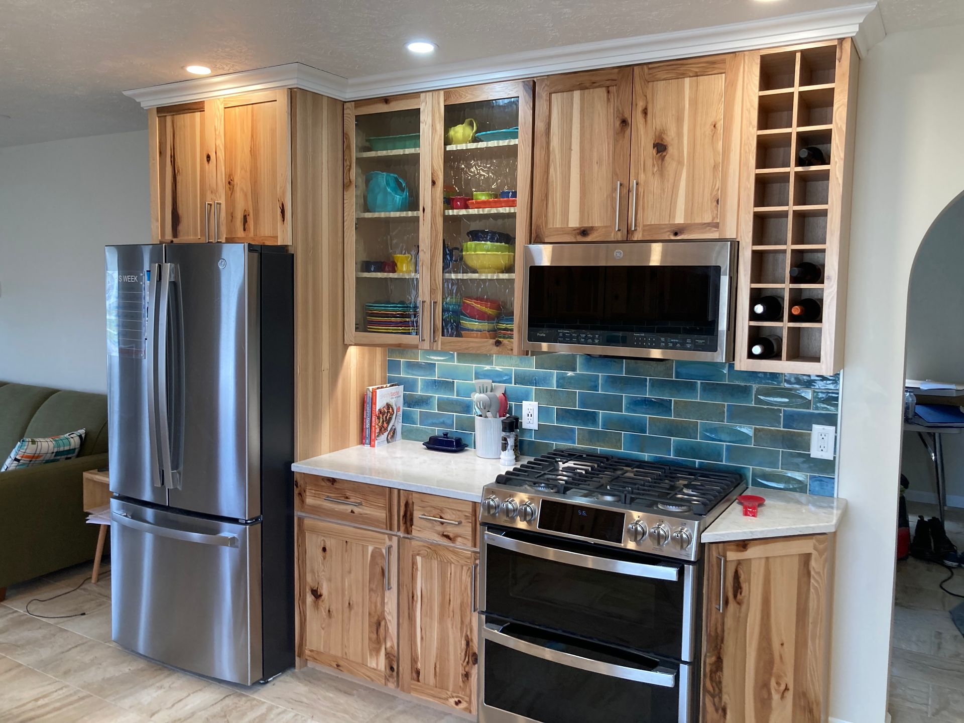 A kitchen with stainless steel appliances and wooden cabinets.