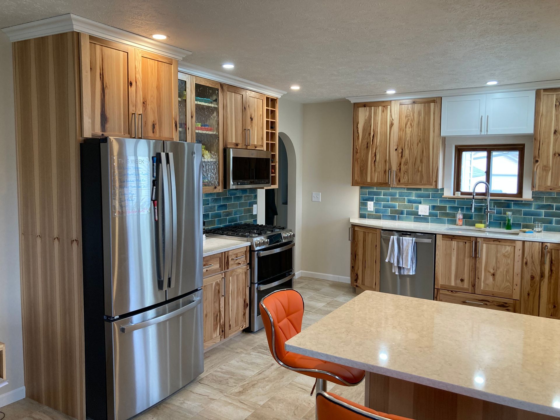 A kitchen with stainless steel appliances and wooden cabinets.