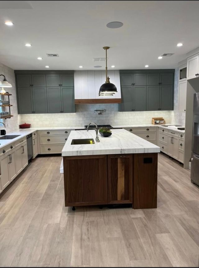 A kitchen with a large island in the middle of it.