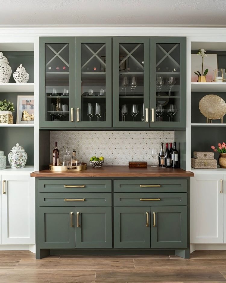 A kitchen with green cabinets and a wine rack.