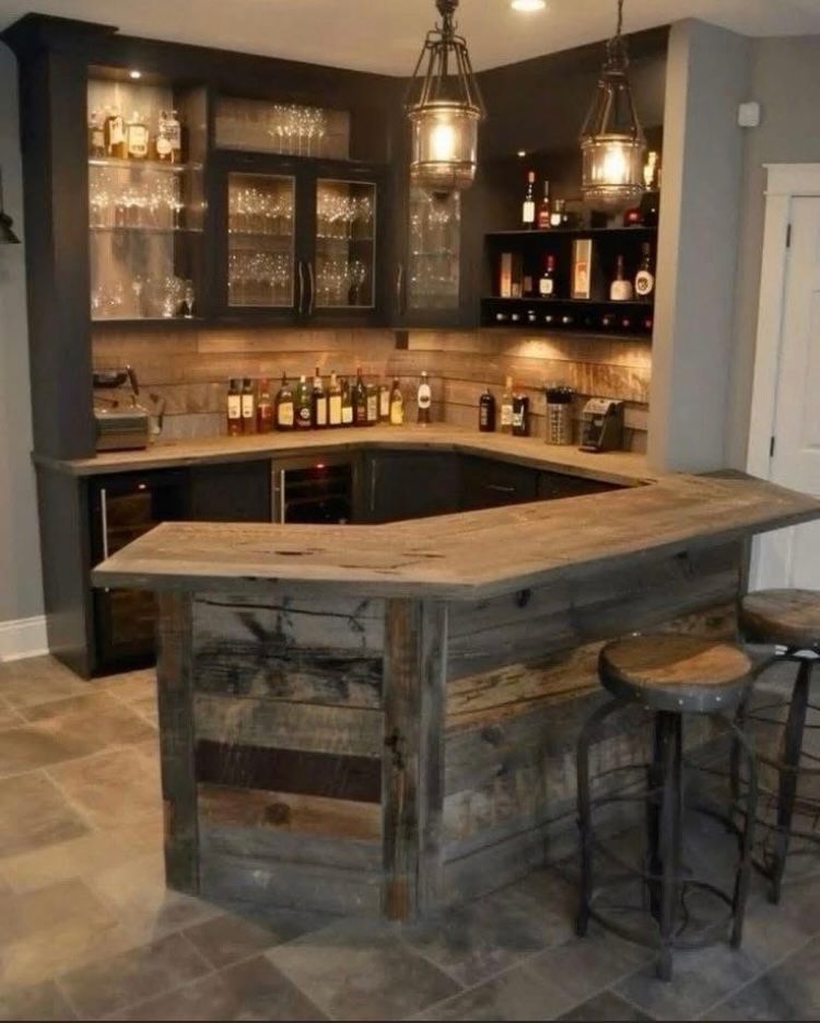 A kitchen with a wooden bar and stools