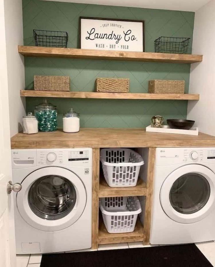 A laundry room with two washers and two dryers.
