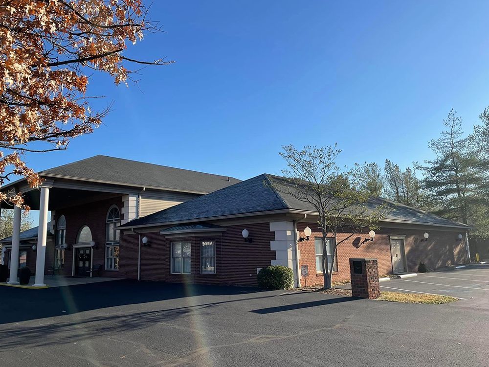 A large brick building with a parking lot in front of it