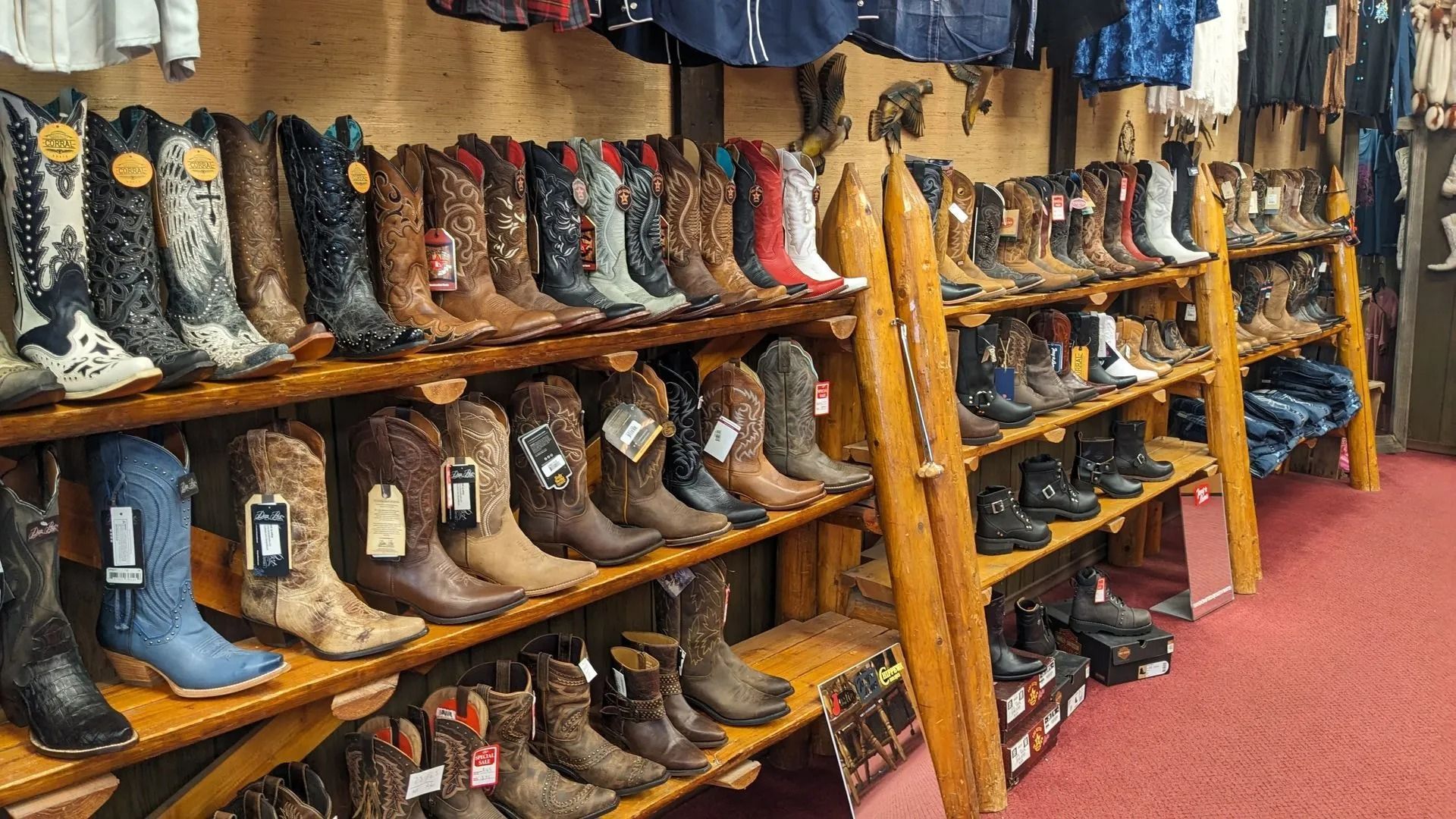 Pair of red leather cowboy boots on display.