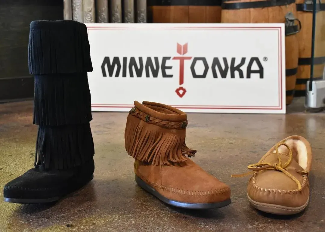 Minnetonka shoes: three styles displayed in front of the company's logo.