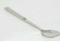 A spoon with a long handle is sitting on a white surface.