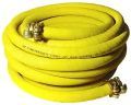 A close up of a yellow hose with two connectors on a white background.