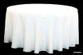 A round table with a white tablecloth on it.