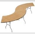 A curved wooden table with metal legs on a white background.