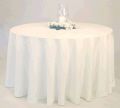 A round table with a white tablecloth and a vase of flowers on it.