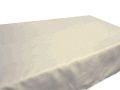 A white pillow is sitting on top of a white table.