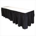 A long table with a black skirt and a white top.