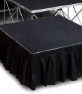 A black stage with a black skirt on a white background.