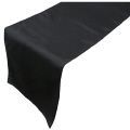 A black table runner is sitting on top of a white table.