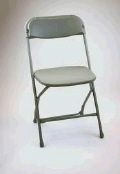 A gray folding chair is sitting on a white surface.