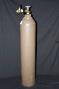 A large cylinder of gas is sitting on a table.