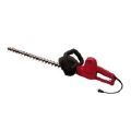 A red electric hedge trimmer on a white background.