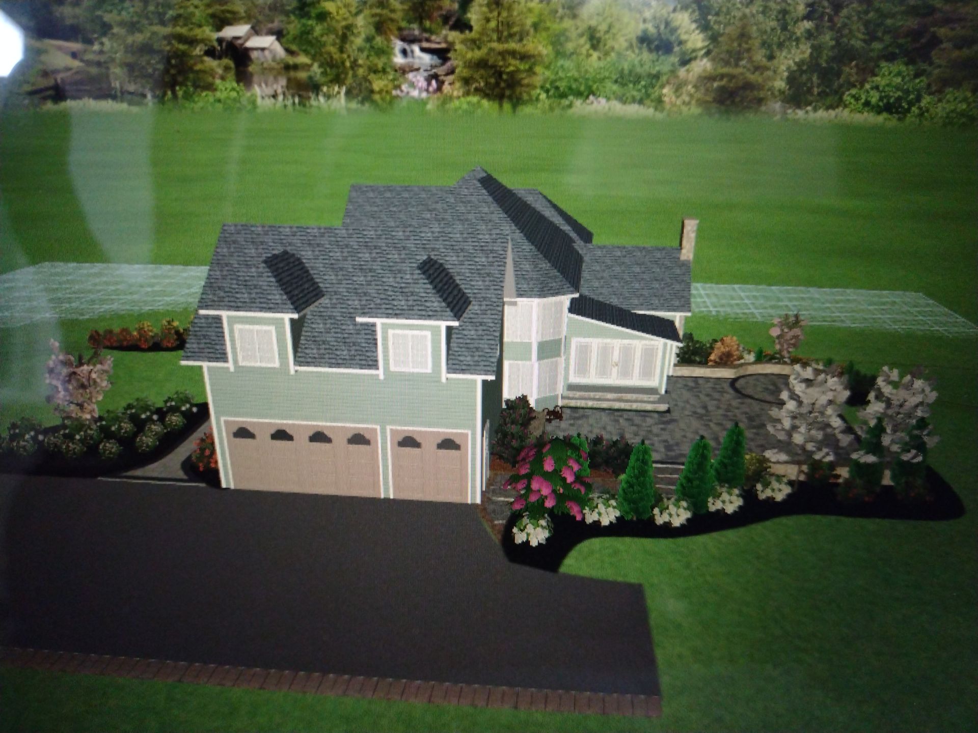 A gray two-story house with a dark roof, double garage, and landscaped front yard in a green setting