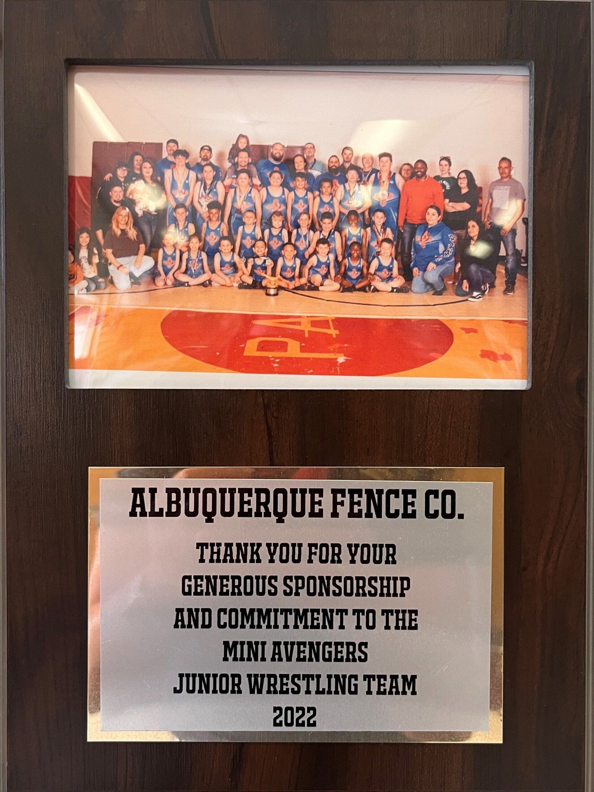 Plaque with team photo. Albuquerque Fence Co. sponsored the Mini Avengers junior wrestling team, 2022.