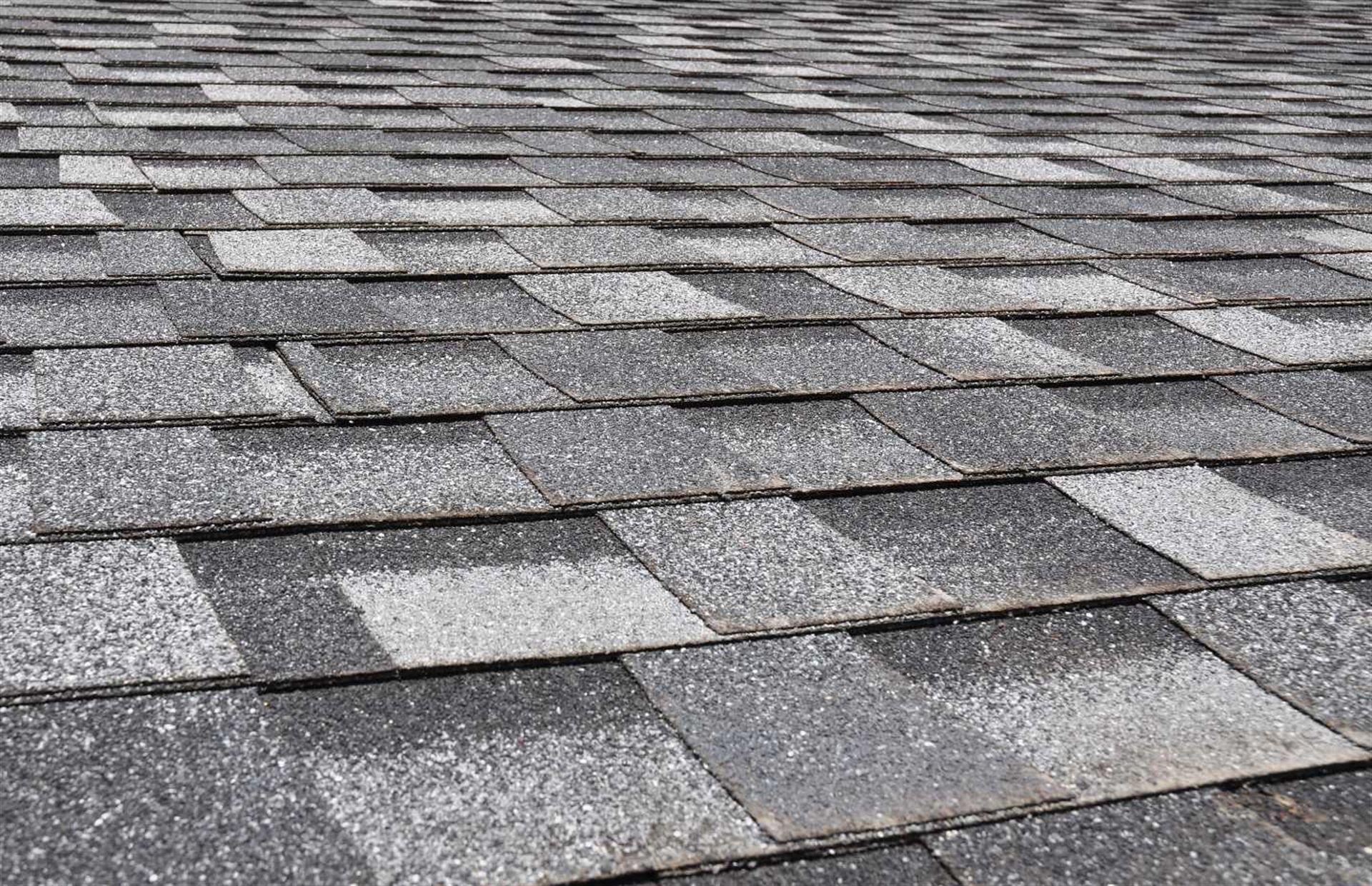 A close up of a roof with a lot of shingles on it.