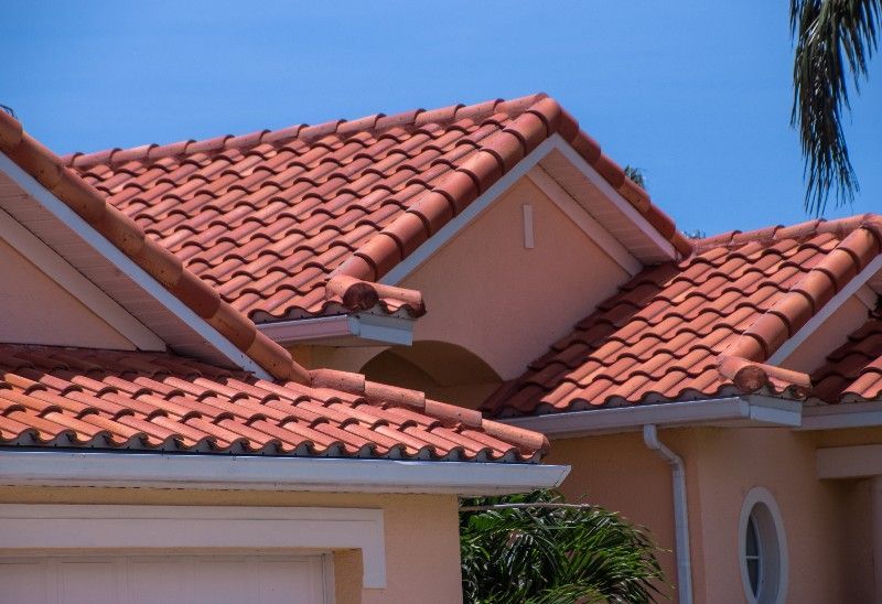 A house with a red tiled roof and a garage.