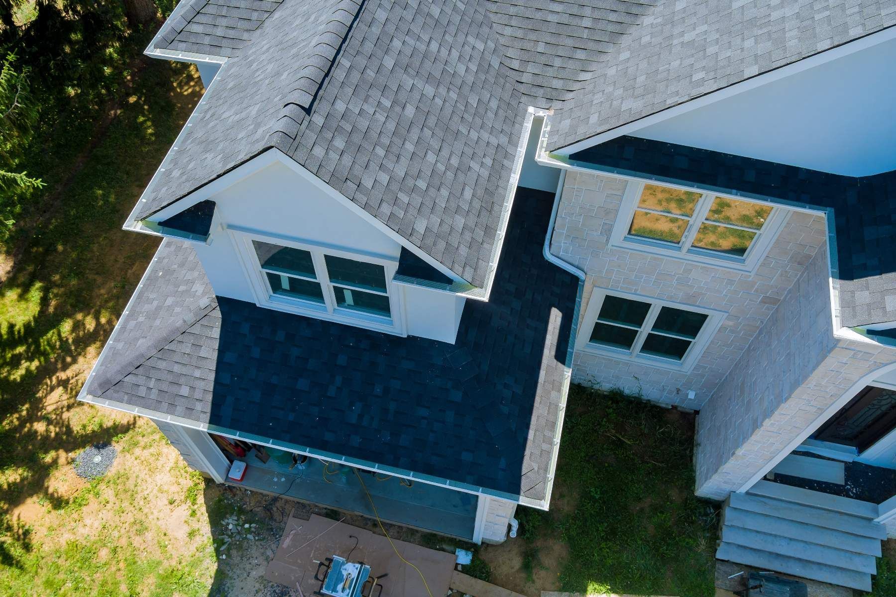 An aerial view of a house with a black roof.