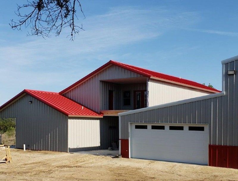 An aerial view of a house with a black roof.