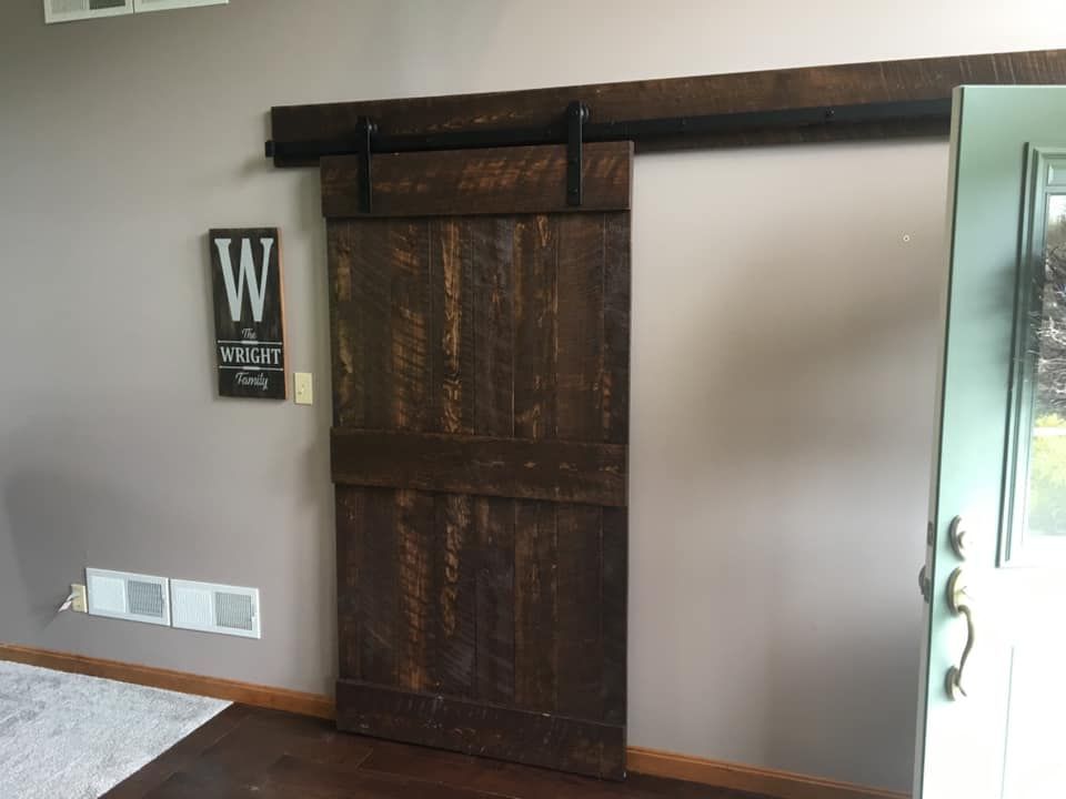 a sliding barn door is hanging on a wall in a living room