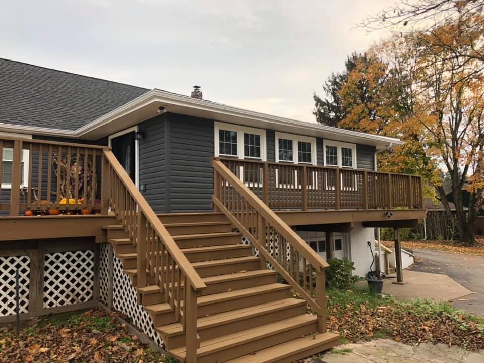 a house with a large deck and stairs leading up to it