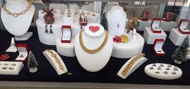 A display of jewelry including a necklace with a heart on it