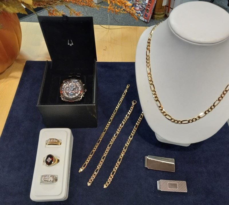 A display of jewelry including a watch and a necklace
