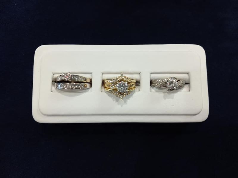 Three rings are displayed on a white tray