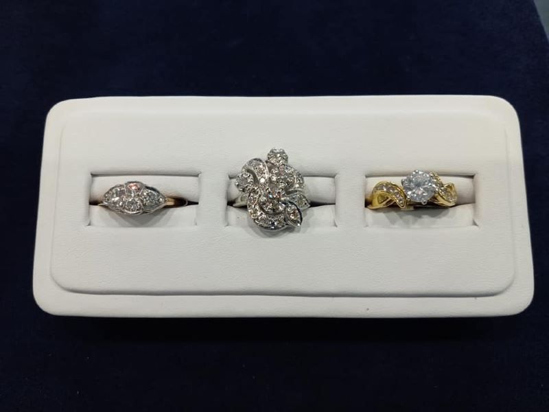 Three rings are displayed on a white tray