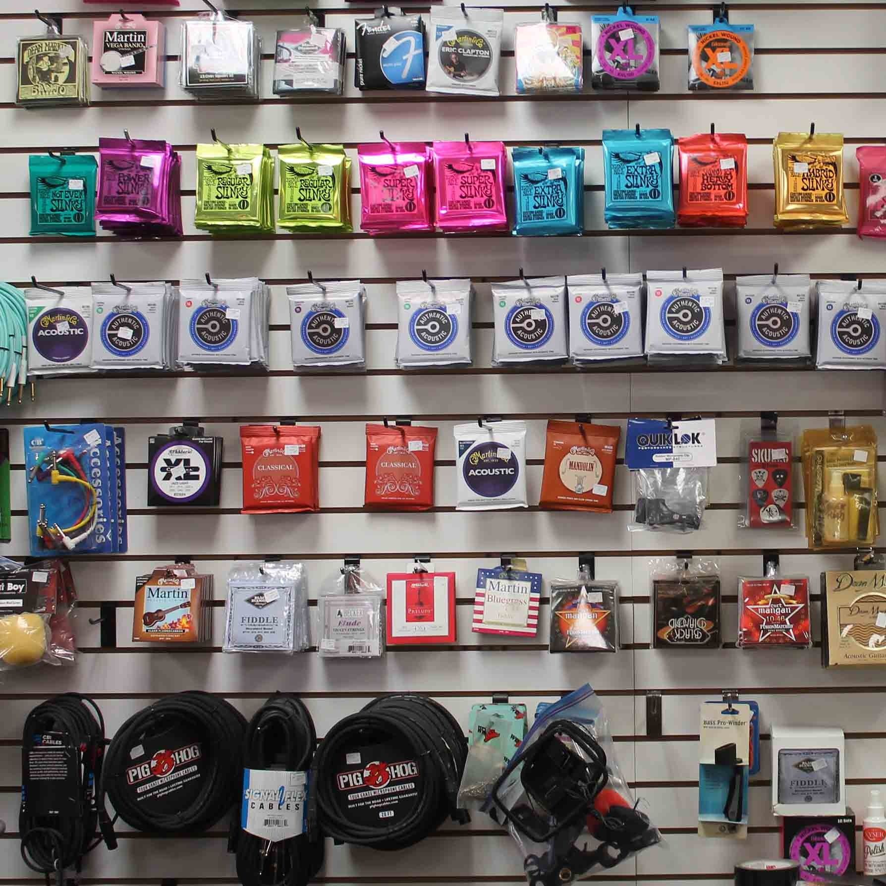 A wall with a bunch of guitar strings on it